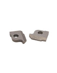 Two small gray metal cutting or tool inserts with circular holes, photographed on a plain light gray background.