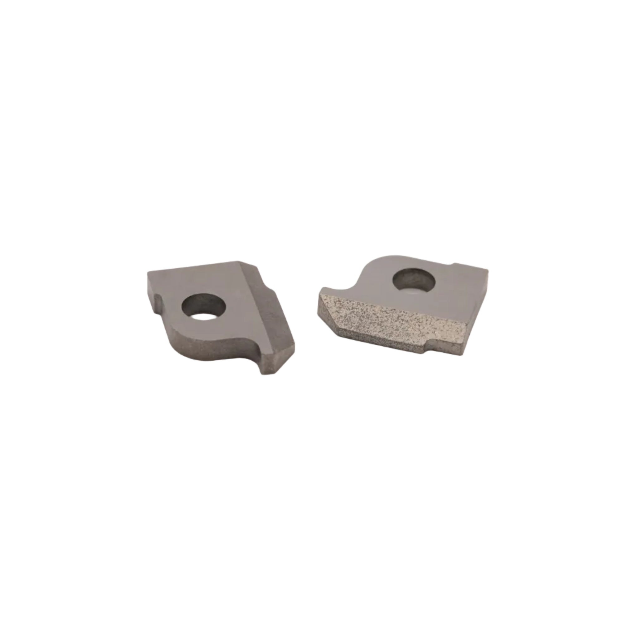 Two small gray metal cutting or tool inserts with circular holes, photographed on a plain light gray background.